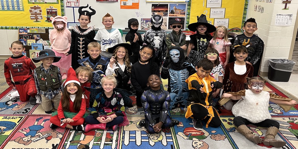 1st grade students taking a class halloween picture